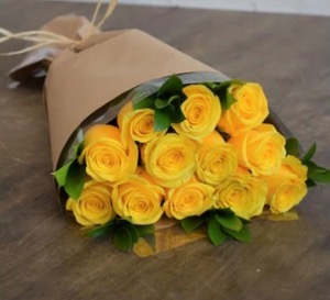 12 yellow roses with greens Hand tied with greens