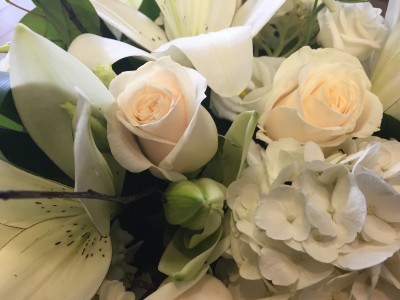 125 White handtied bouquet wrapped in cellophane - not arranged in a vase 