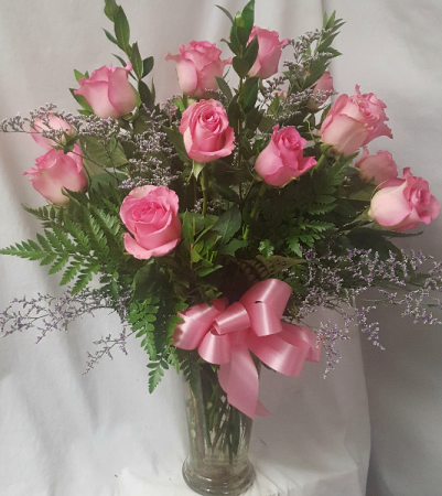 18 PINK LONG STEM ROSES..(R).. arranged   in a vase with limonium if in season or baby's breath.