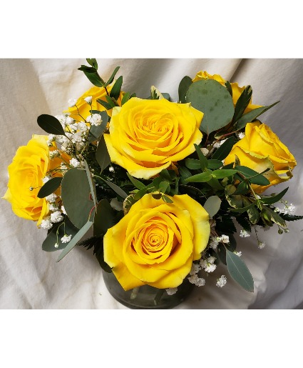 6 Bright Yellow Roses arranged all the way (R) around In a vase.