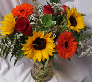 "A Fall Favorite"...(F) seasonal flowers roses,  Sunflowers, gerbera daisies with filler arranged