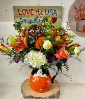 A friendly ghost pitcher ceramic container of fresh flowers