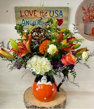 A friendly ghost pitcher ceramic container of fresh flowers