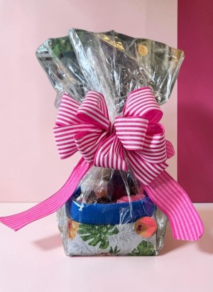 A Moment for Her Basket Tea, chocolate, pampering bath favorites, and a little time to unwind—all beautifully packaged in a reusable basket.