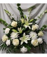 All white flowers arranged. (S) Flowers may vary depending on stock and time frame when ordering but they will be all white. Also if delivering to home we will put in a vase.