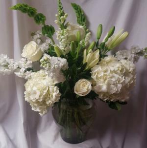 All white seasonal flowers in a vase (E) 