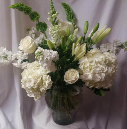All white seasonal flowers in a vase (E) 