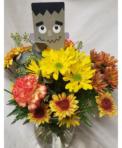 HALLOWEEN BOUQUET....BRIGHT FALL (HA) flowers arranged in a vase with a wooden Halloween pic!