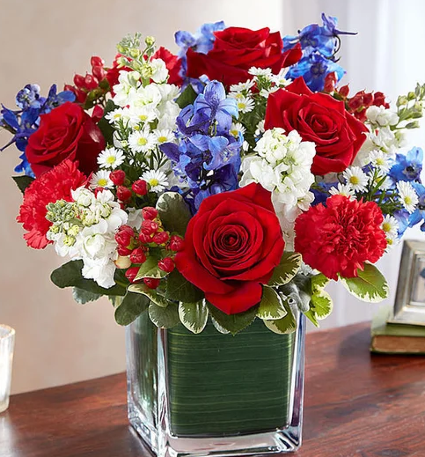 Arrangement: Red, White and Blue AN ARRANGEMENT MADE  WITH DIFFERENT TYPES OF FLOWERS: ROSES, MONTE CASINO, DELPHINIUM, ETC.