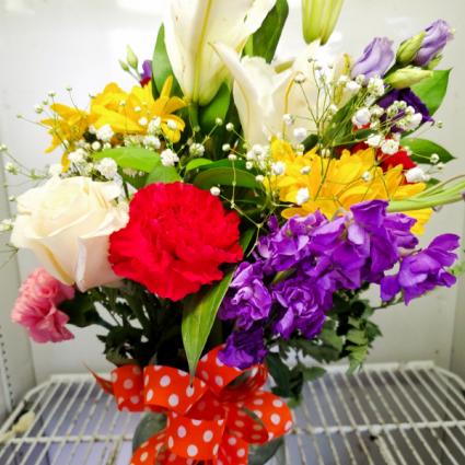 Be Mine Valentine! Mixed Flowers including some Roses designed in a Glass vase to set perfectly on the center of a table. 