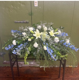 Blue flowers  and white flowers  Casket spray 