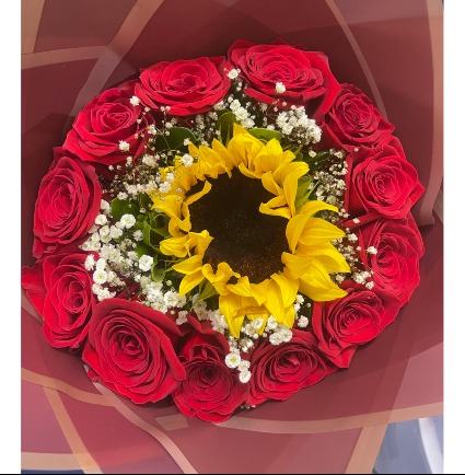 Bouquet  12 red roses with a sunflower in the middle, and baby breath