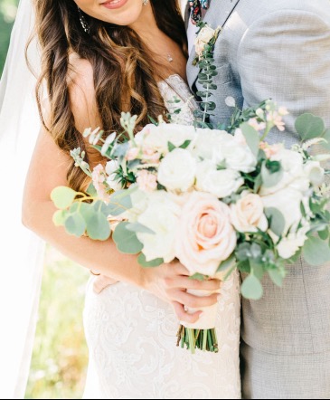 Bridal bouquet  Assortment of roses and baby eucalyptus and silver dollar wrapped with a nice ivory satin ribbon  in Tampa, FL | MILLY'S FLOWERS