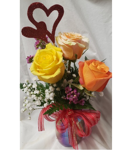CANDY HEARTS. 3 mixed ROSES  (VD) In a  iridescent vase with heart pic and seasonal filler and bow. 