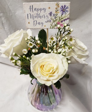 DELIGHTFULLY MOM...3 white roses in a  (MD) iridescent small vase with seasonal filler and price INCLUDES Mother's Day pick!