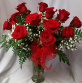 Dozen Red Roses arranged in a vase with (R) baby's breath and ribbon!