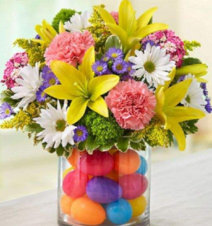 Easter Arrangement Made with a variety of flowers: carnations, lilys, monte casino, daisies, etc.