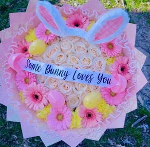 #6 Easter bouquet 50 white roses, with yellow carnations, and pink gerber daisies. With plastic easter eggs.