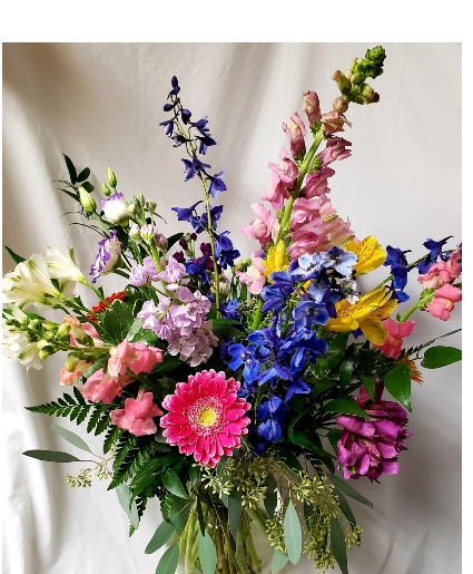 Easter Delight! Mixed spring flowers  (HE) arranged in a vase with seasonal flowers