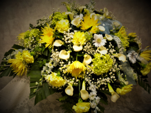 Elegance in shades of Yellows casket spray