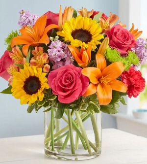 Embrace Arrangement Mix arrangement with roses, sunflowers, lilys, etc.