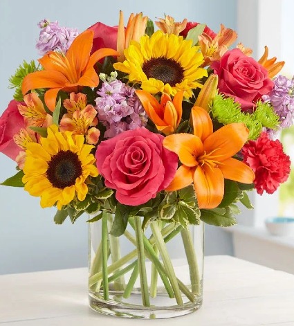 Embrace Arrangement Mix arrangement with roses, sunflowers, lilys, etc.