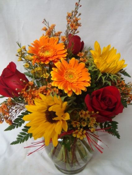 A Fall Favorite!! Roses, Gerbera daisies and (F) Sunflowers arranged with filler!