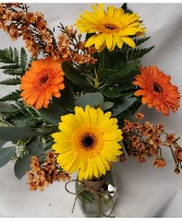 GERBERA BRIGHTS...4 gerbera daisies  (E) with filler in a vase ( colors may vary)