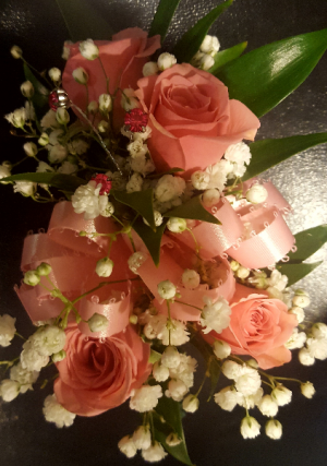 Wrist corsage with 4 spray roses and filler. (CO) Visit corsage link 