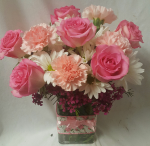 "PINK DELIGHT"...(E)....PINK ROSES, PINK Carnations and white daisies  OR white cushions  with filler arranged in a cute ribbon detailed rectangular vase! (rose color may vary light or med pink)
