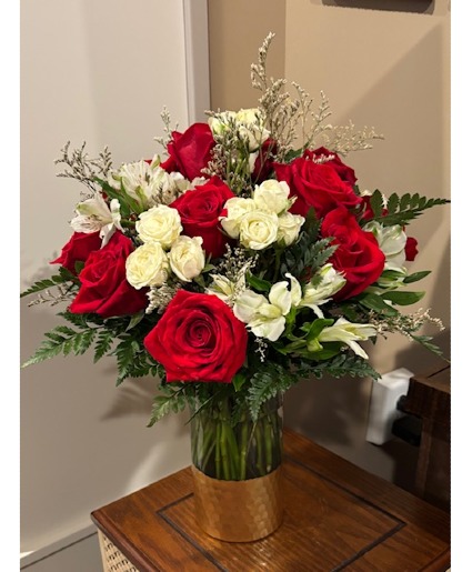 Gold Medal Roses Arrangement in a glass vase with a gold bottom