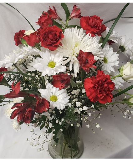 Graduation Bouquet! Miami colors  (G) red and white flowers arranged in a vase.