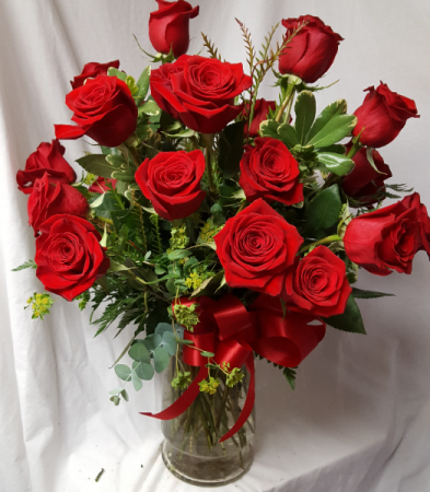 24 Red Roses arranged in a vase with (R) seasonal Greens and bow!