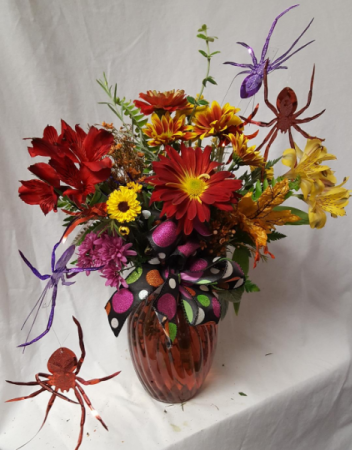 SPOOKY SURPRISE.....ARRANGEMENT..(HA) Bright fall flowers with spiders and Halloween decor.