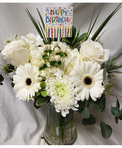 HAPPY BIRTHDAY DELIGHTFULLY WHITE! (B) All whites flowers arranged in a vase with a Happy Birthday pick! Flowers will be all white but may vary with the kinds of flowers depending on stock. 