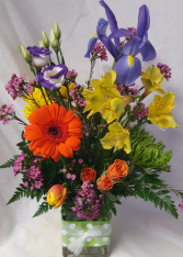 HAPPY DAYS BOUQUET..cute fabric on a (E) Vase filled with bright seasonal flowers.