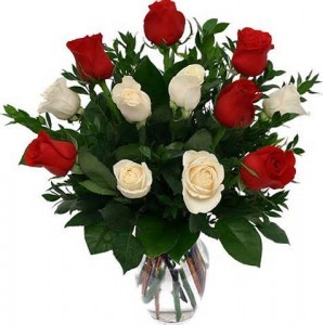 Dozen Red and White Roses arrranged in (R) a vase with greens only no filler flower