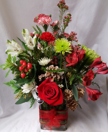 Green and red colors arranged in a cute (E) rectangular vase with ribbon detail!