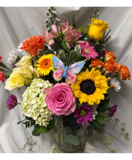 IN THE GARDEN…seasonal bright mixture of  (E)  Flowers Arranged in a vase with a butterfly pic! Flowers may vary depending on stock