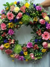 Beautiful Round Wreath with a mixture .(S) of colors. We need a few days  notice.