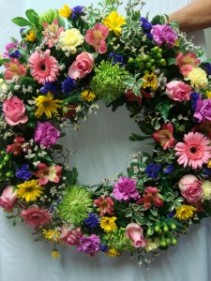 Beautiful Round Wreath with a mixture .(S) of colors. We need a few days  notice.