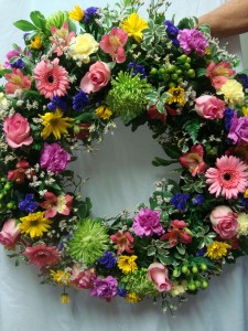 Beautiful Round Wreath with a mixture .(S) of colors. We need a few days  notice.