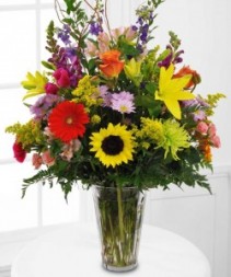 MEMORABLE TRIBUTE Bright Seasonal (S)   flowers arranged in a clear vase