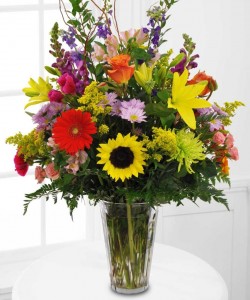 MEMORABLE TRIBUTE Bright Seasonal (S)   flowers arranged in a clear vase