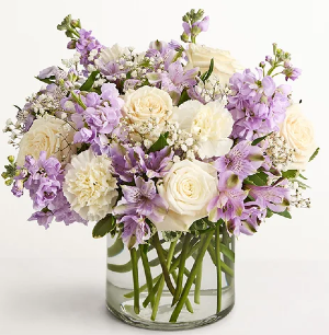 Lavendar and White Arrangement FUNERAL ARRANGEMENT MADE WITH DIFFERENT TYPES OF FLOWERS: ROSES, CARNATIONS, BABY BREATH, STOCK, ETC.