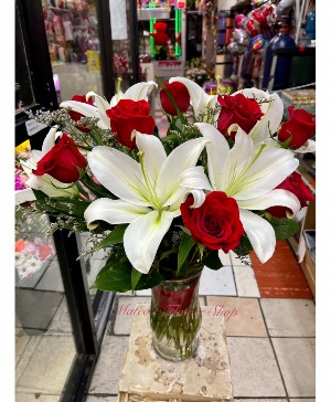 Llilies and roses in a vase  tall arrangement 
