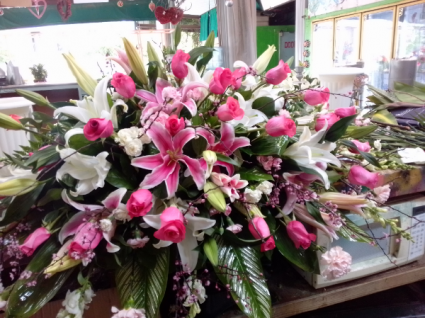 Magnificent casket spray funeral Lilies roses and more