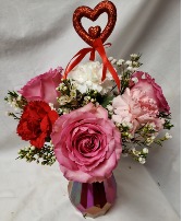 "CUPID CREATION"(VD)includes 3 PINK ROSES, FILLER Heart pic, red, white and pink carnations in a colored cinched vase ( vase color may vary)