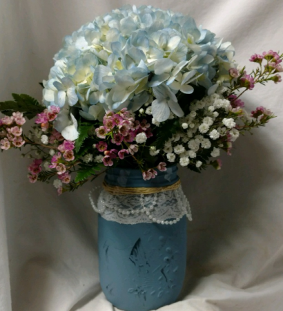 One pretty blue hydrangea in a mason jar (E) with wax flower!