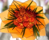 wrapped orange roses in orange paper 